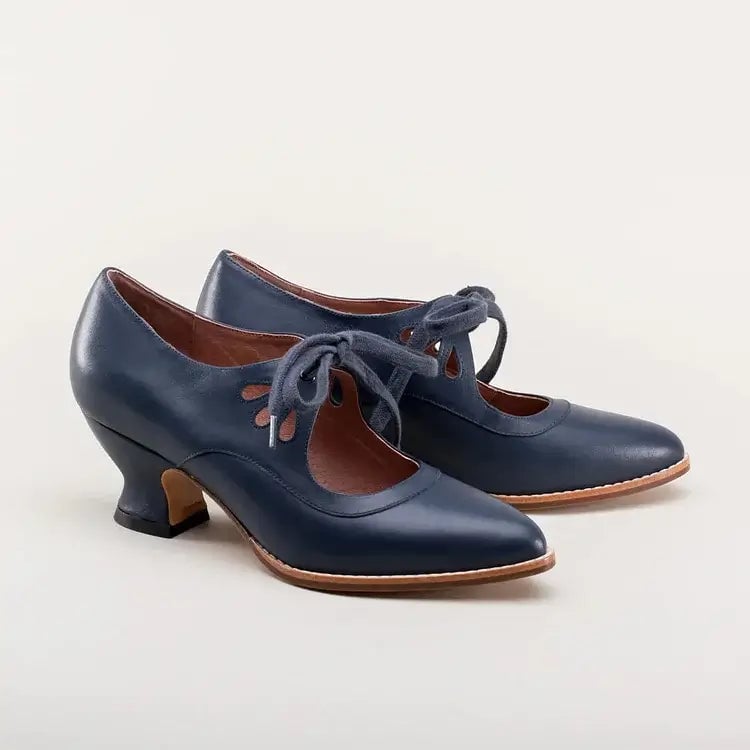 Flat lay of Amelia vintage heels in all five color options: black, white, brown, blue, crimson red