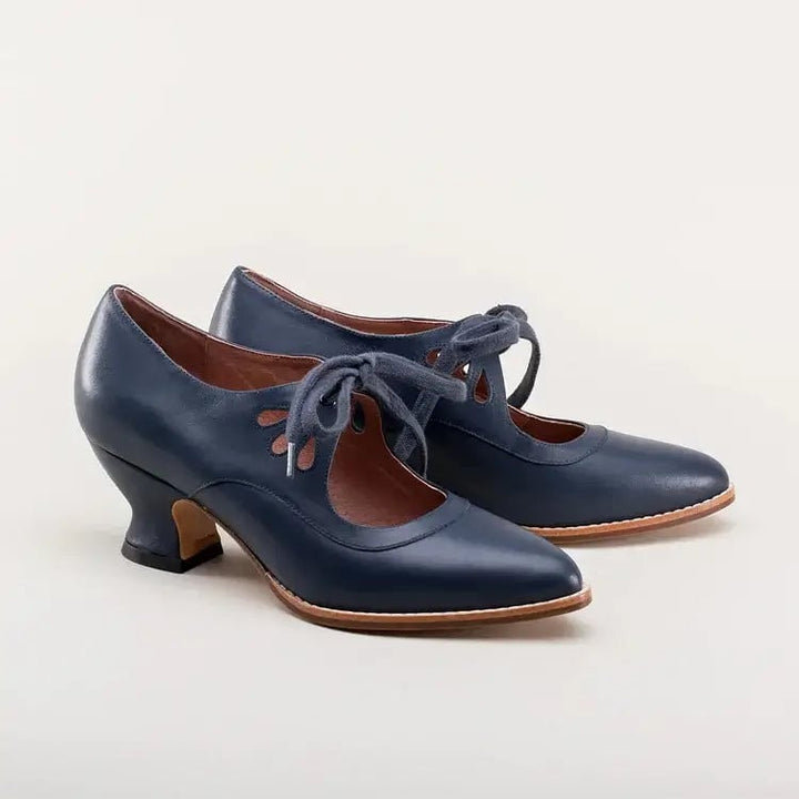 Flat lay of Amelia vintage heels in all five color options: black, white, brown, blue, crimson red