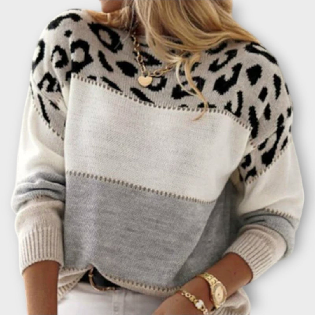 Model wearing the Amelia elegant sweater in brown paired with trousers for a smart casual look