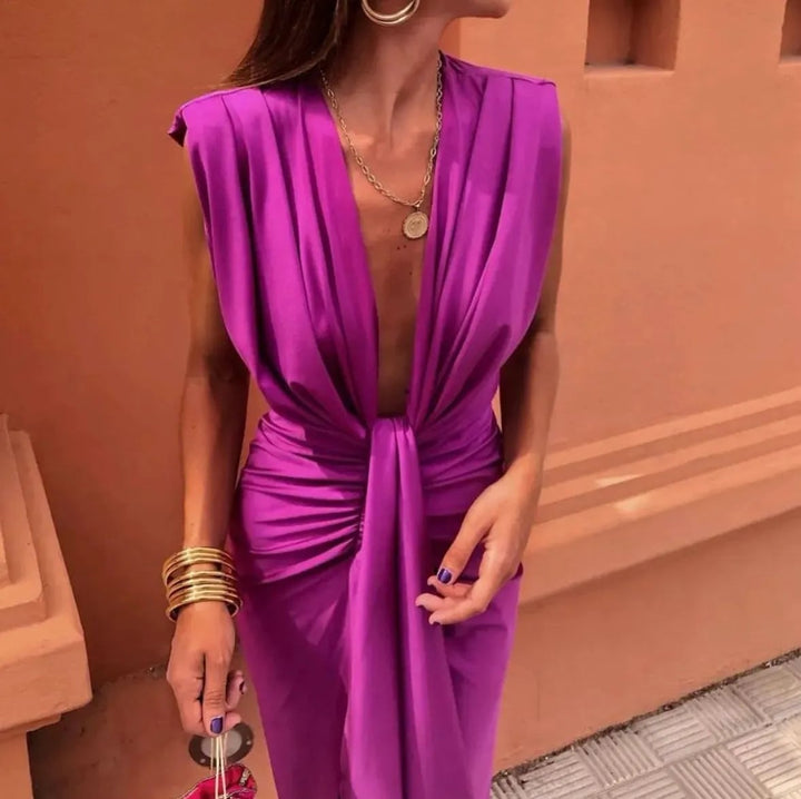 Lifestyle shot of the Amelia Soft Pleated Midi Dress in fuchsia styled with heeled sandals