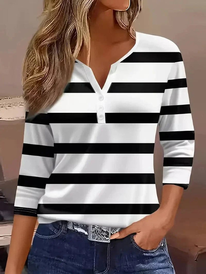 Model wearing the Amelia striped V-neck top paired with casual bottoms, full-length view