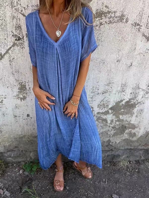 Front view of a soft loose-fit V-neck dress showing the elegant neckline and relaxed silhouette
