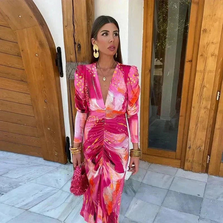 Woman wearing a blush pink wrap maxi dress with a flowing silhouette, styled for a wedding guest occasion