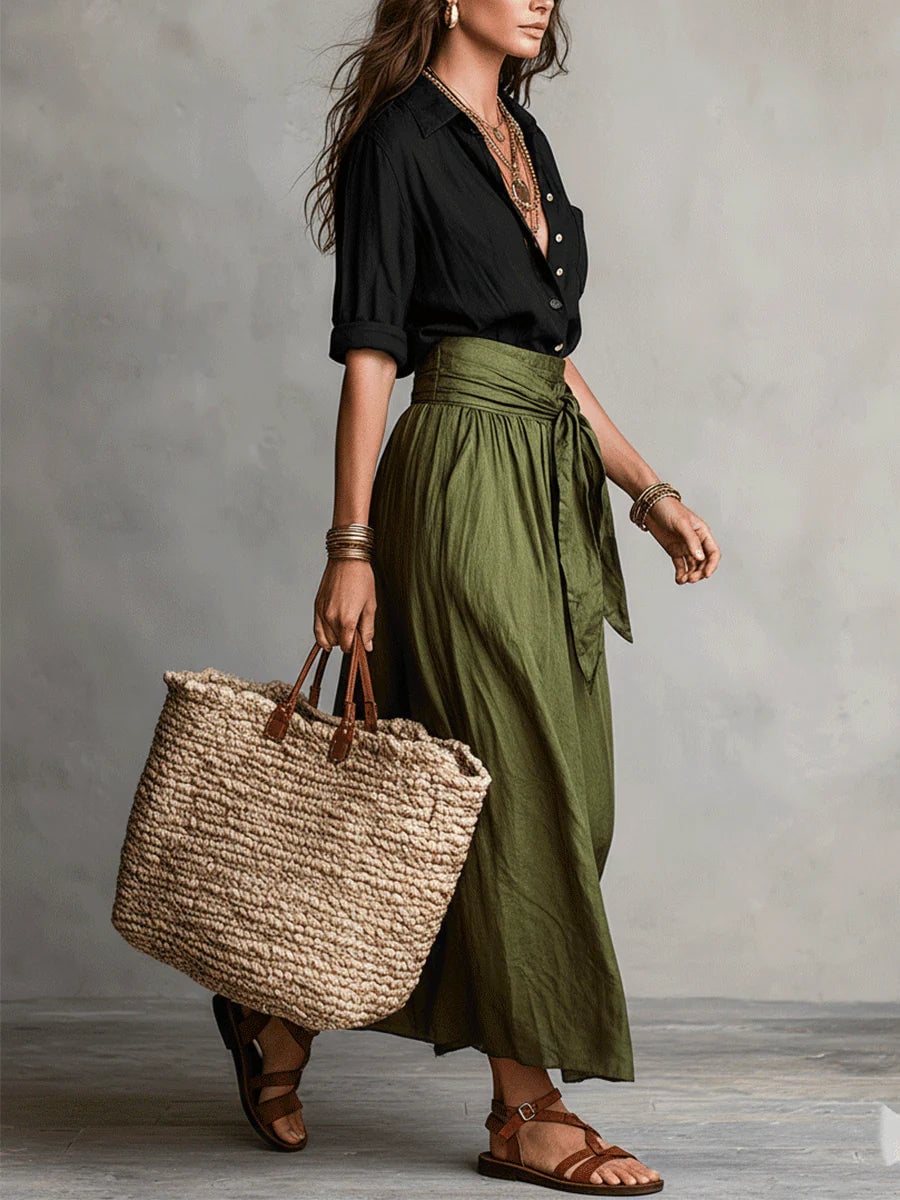 Close-up of the Anastasia green two piece set showing the v-neckline and button-up blouse detail
