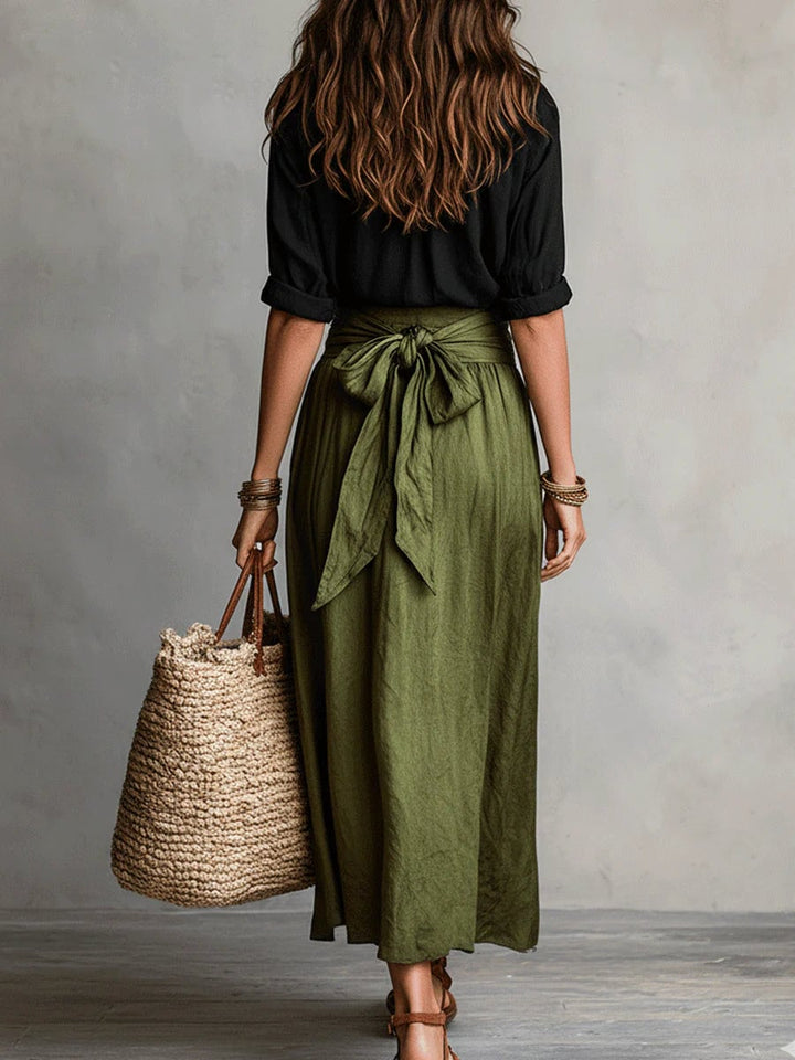 Side view of the Anastasia women's green high-waisted maxi skirt and 3/4 sleeve blouse set