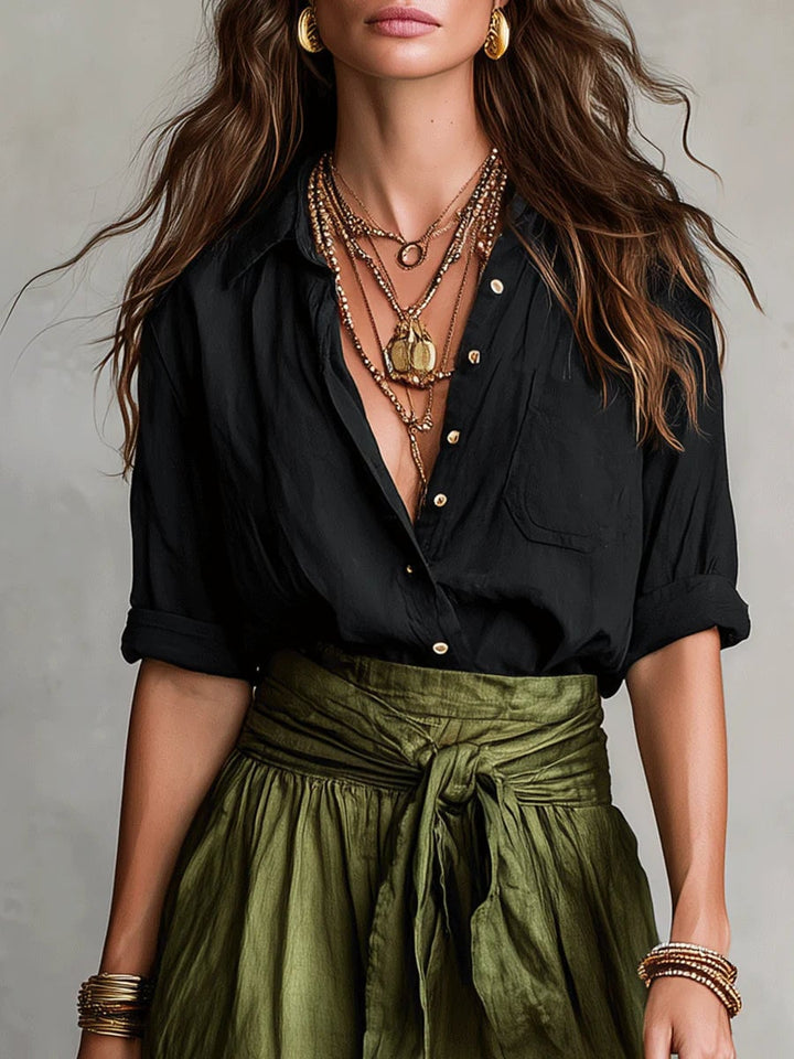 Back view of the Anastasia button-up two piece set in sage green with flowing maxi skirt