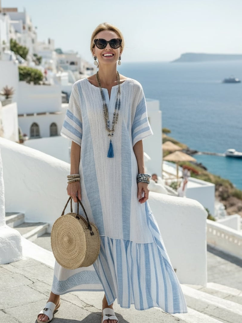 Woman wearing the Anastasia blue vertical striped short sleeve maxi dress with a round neckline, front view