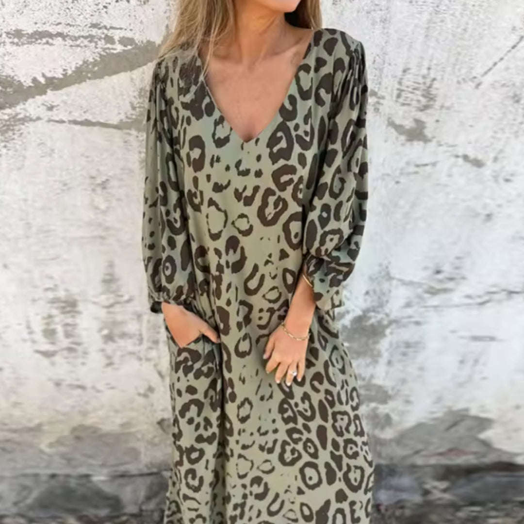 Woman wearing the Andrea flowing spring dress in a vibrant multicolor print with relaxed long sleeves and a V-neckline