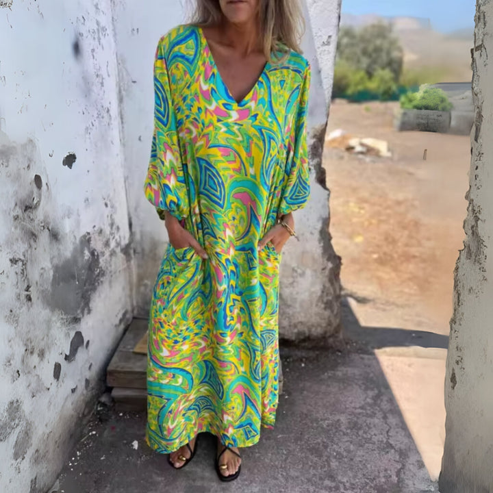 Model wearing the Andrea spring dress in green at an outdoor garden setting