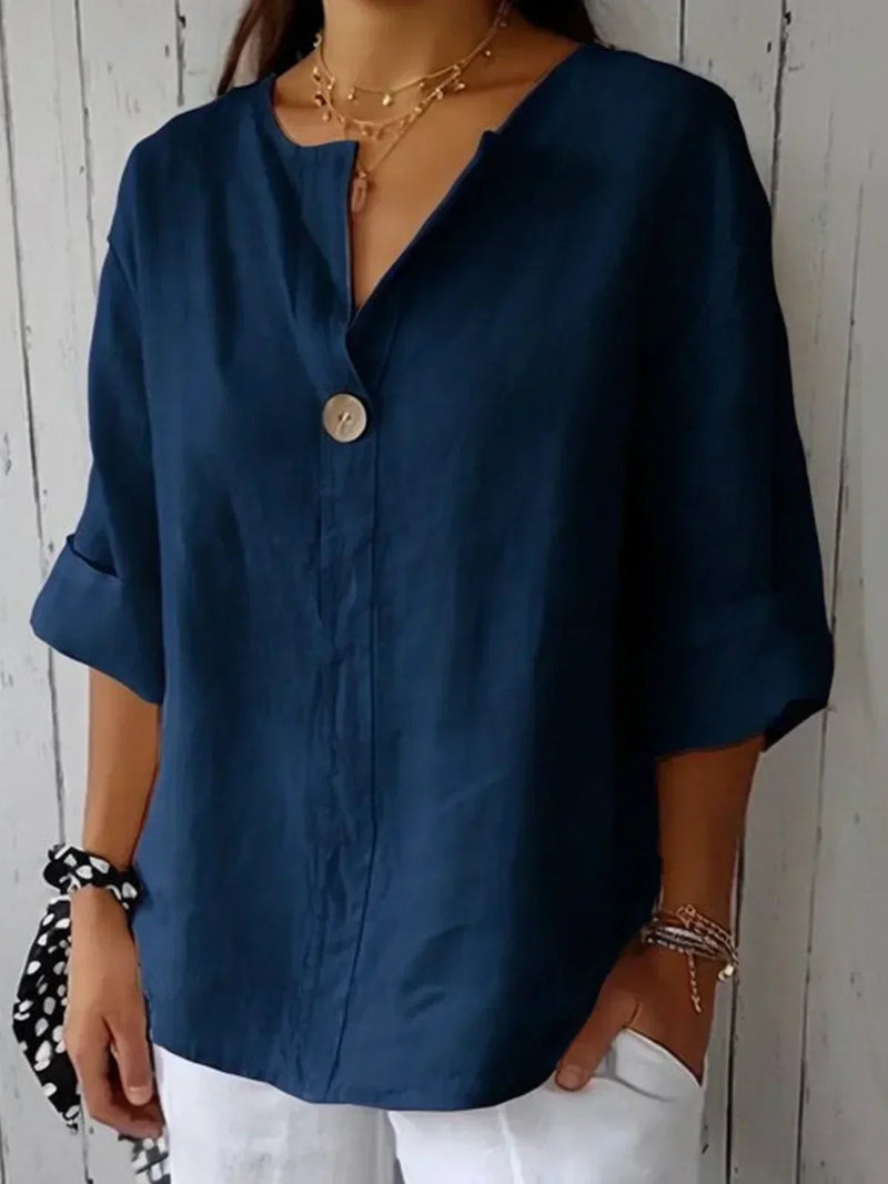 Front view of the Angela casual V-neck blouse styled with jeans, shown in white