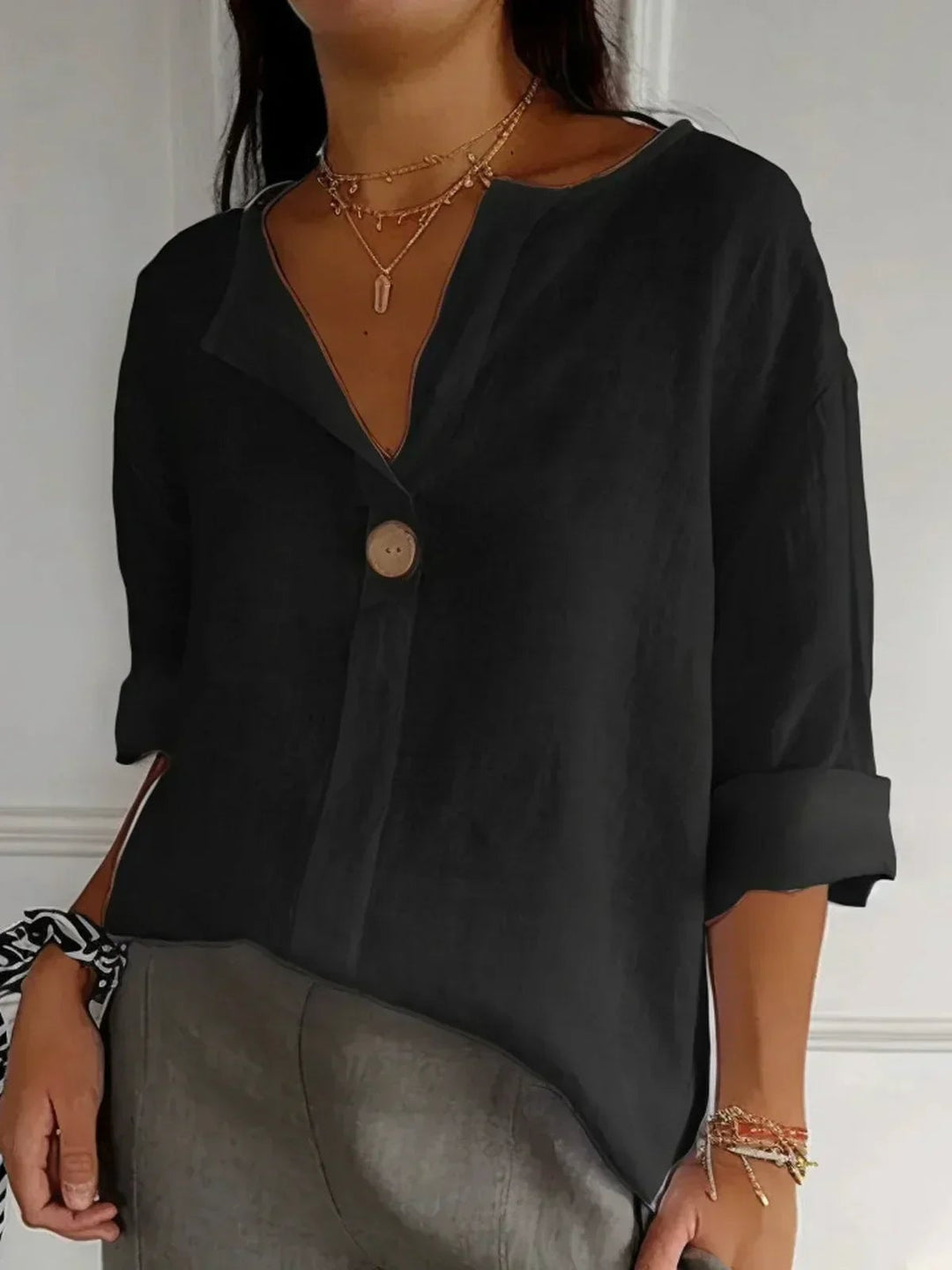 Side view of the relaxed loose silhouette of the Angela V-neck blouse in navy blue