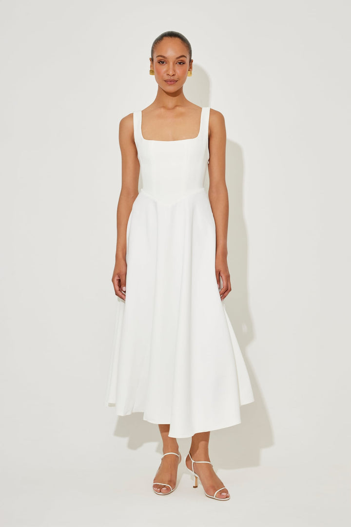 Front view of the Florimay flowy midi dress in white with a square neckline and fitted waist
