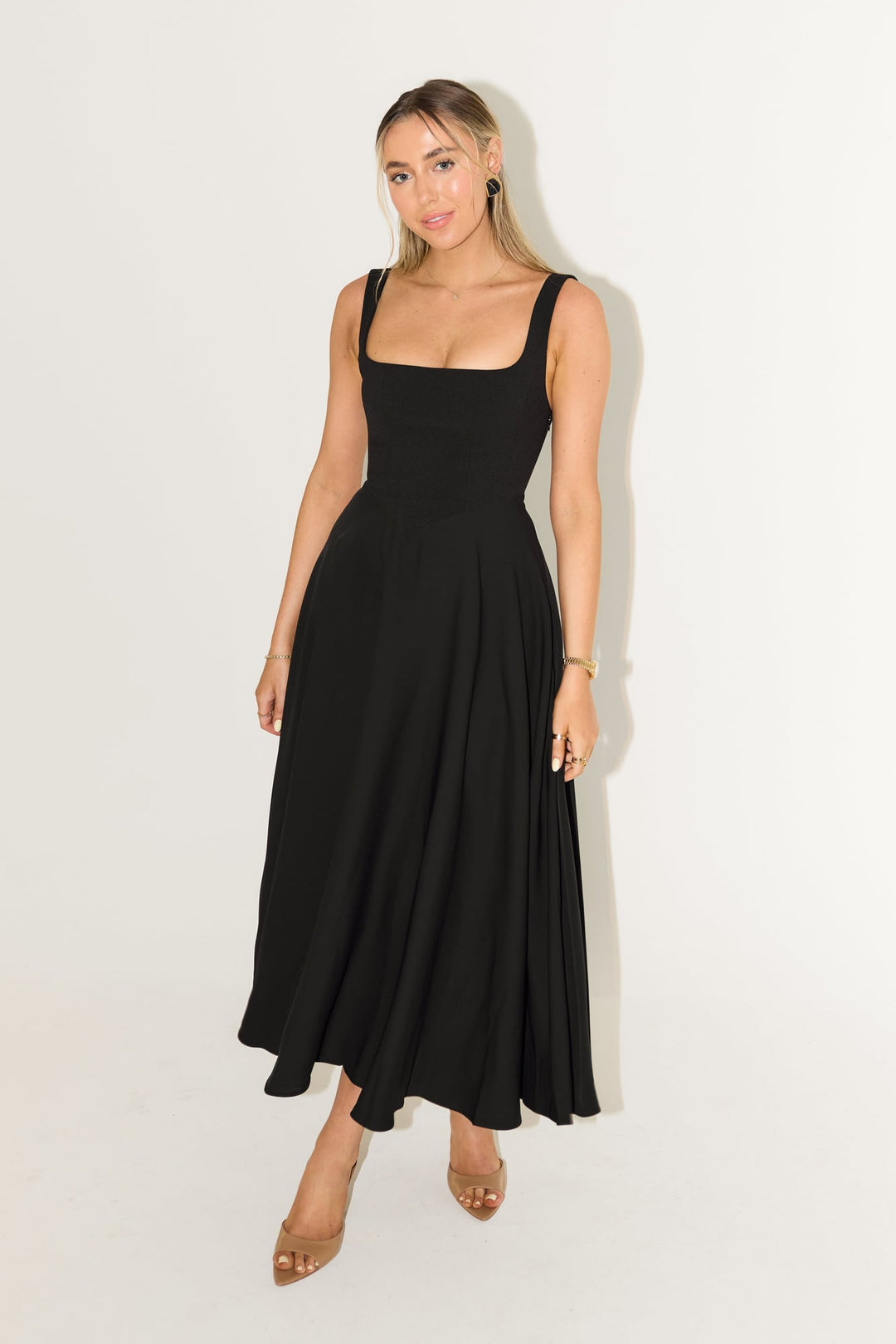 Side view of the flowy white midi dress showing the graceful skirt movement