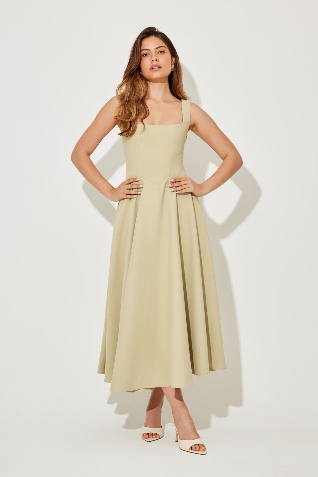 Full-length shot of the Florimay midi dress in black with a waist-defining silhouette