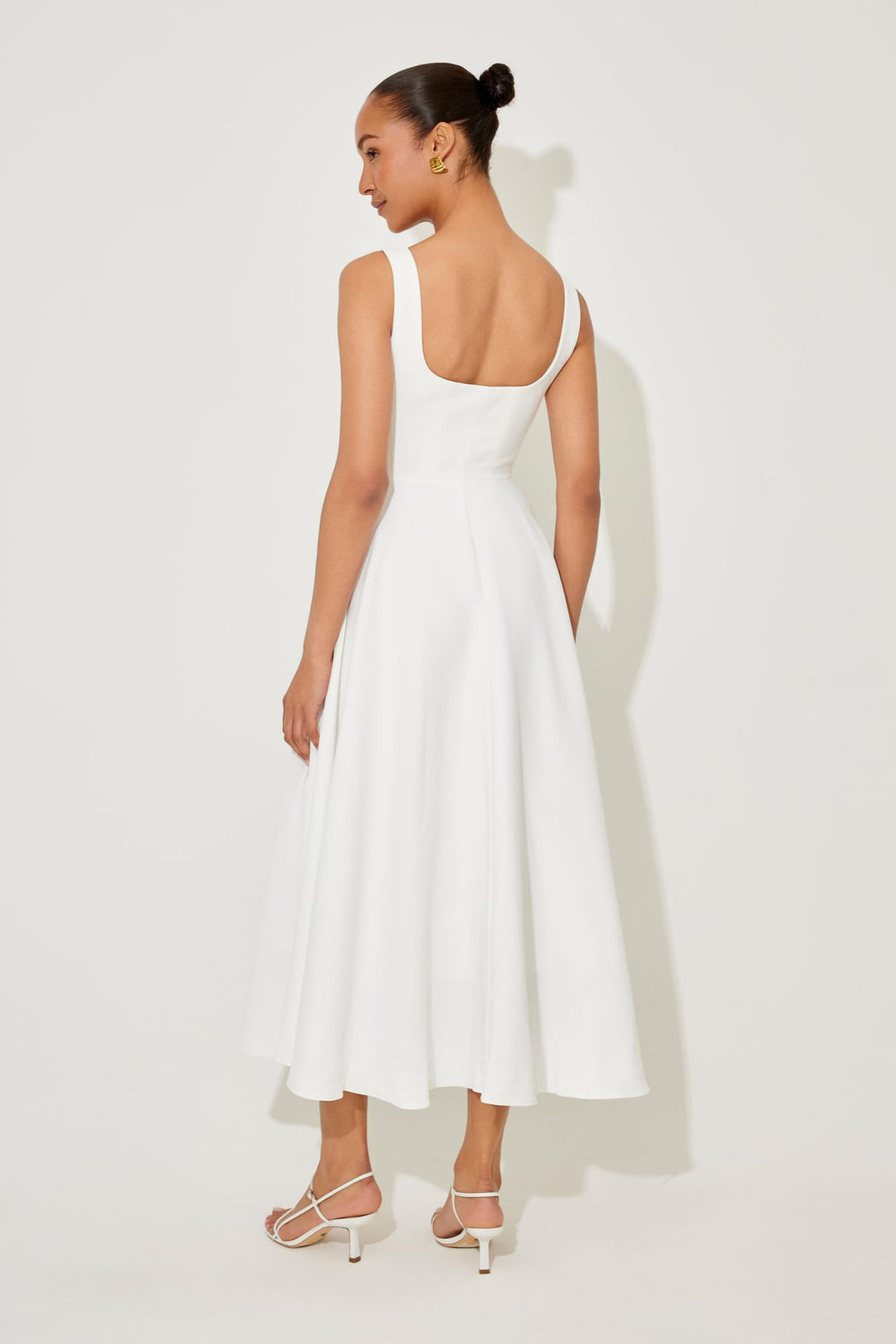 Florimay flowy midi dress in red, front view showing the fitted waist and flowing skirt