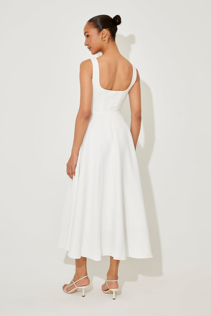 Florimay flowy midi dress in red, front view showing the fitted waist and flowing skirt
