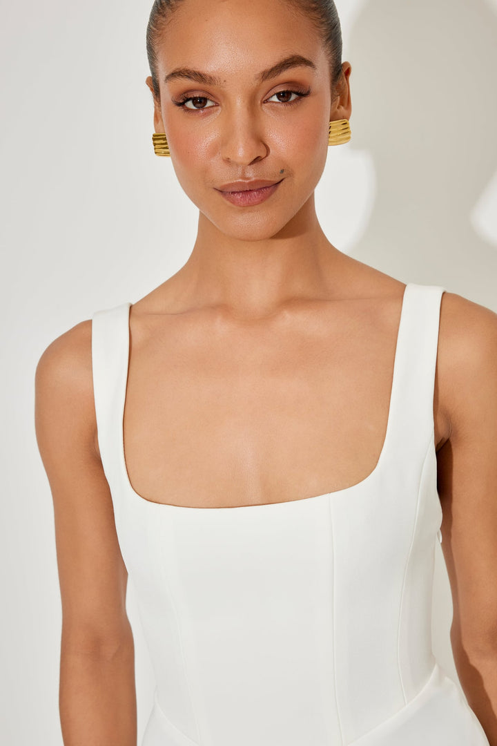 Close-up of the waist detail on the red flowy midi dress