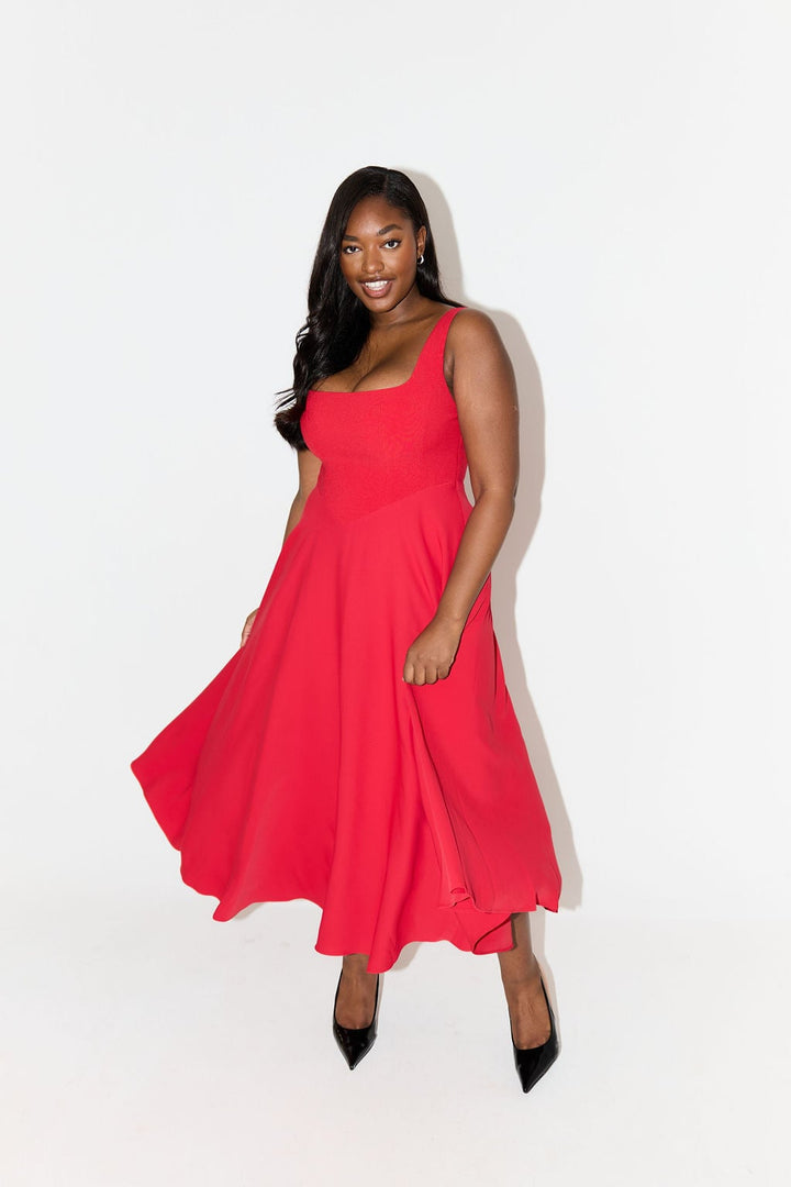 Flat lay of the black flowy midi dress from Florimay