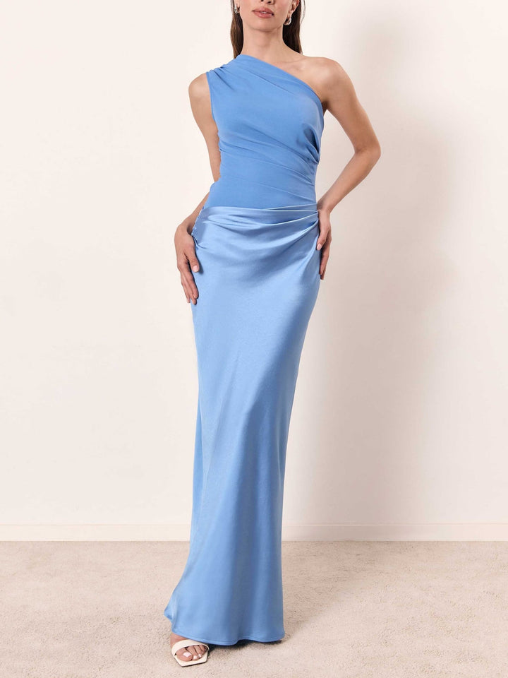 Model in a blue one-shoulder pleated formal maxi dress, full-length silhouette