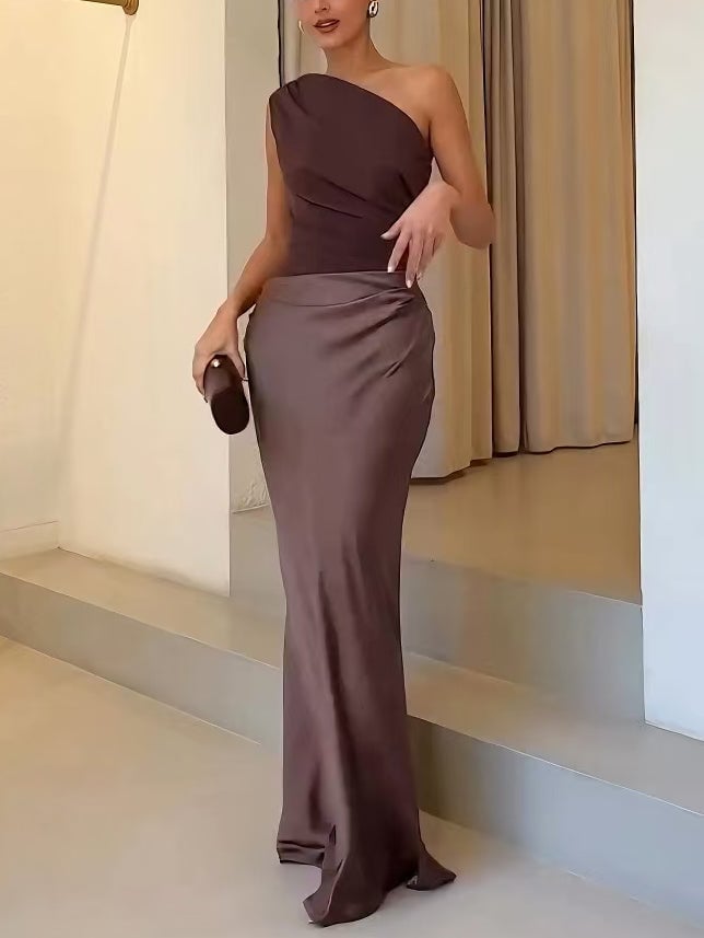 Back view of a blue elegant one-shoulder maxi dress with flowing skirt
