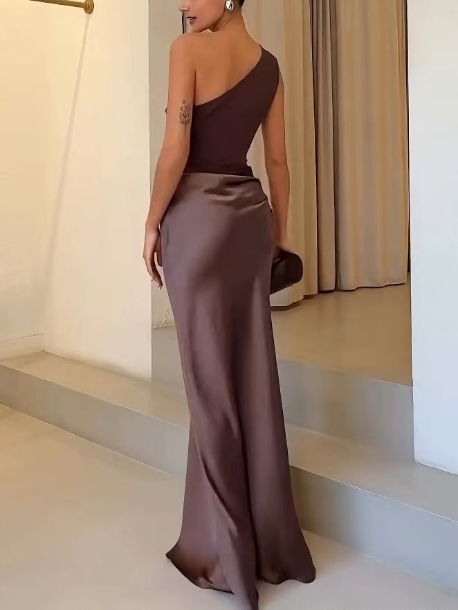 Full-length shot of a brown one-shoulder pleated maxi dress on a model