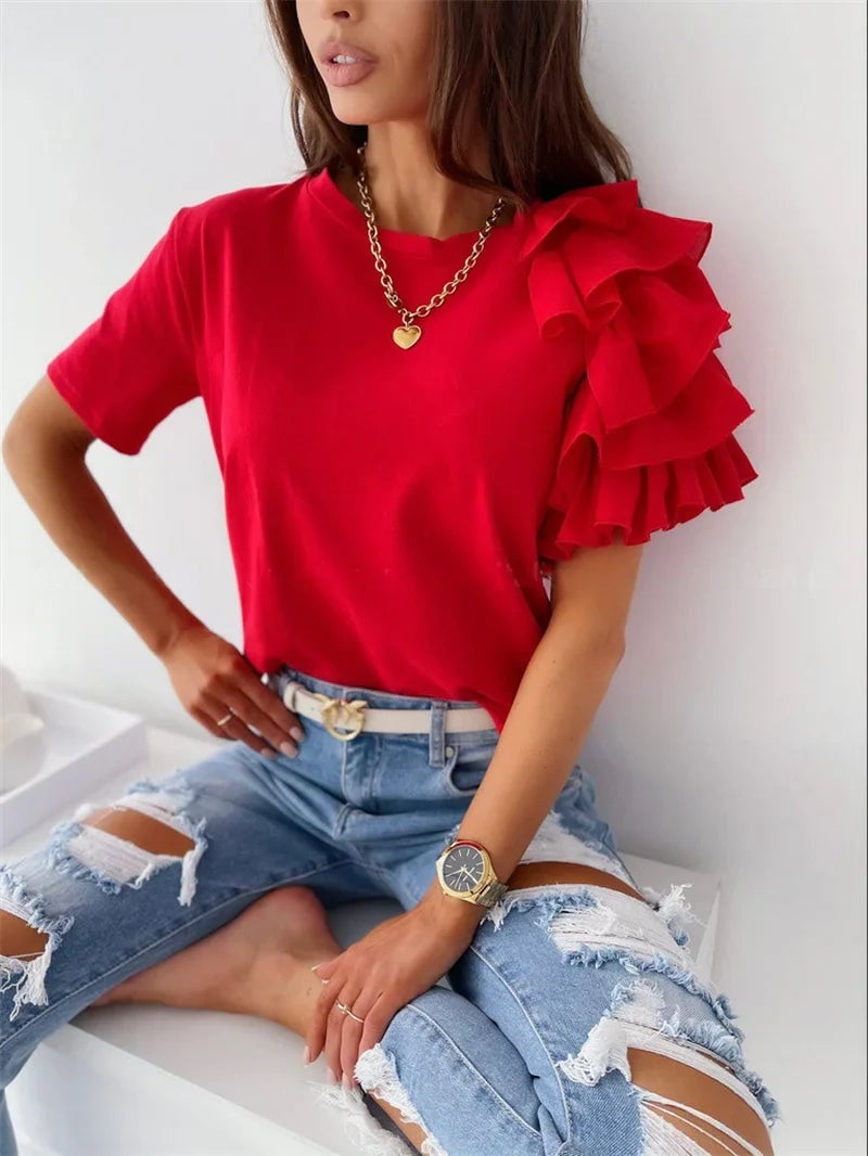 Woman wearing a red ruffle one-shoulder top with a relaxed straight-cut fit, styled casually