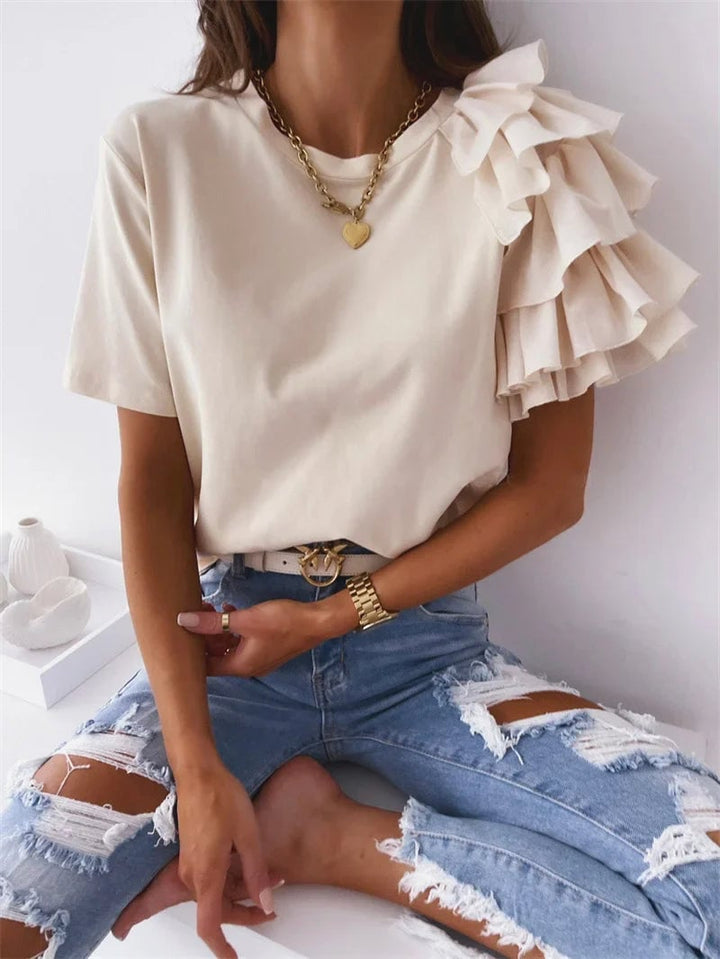Front view of a beige ruffle one-shoulder top showing the flattering straight-cut silhouette