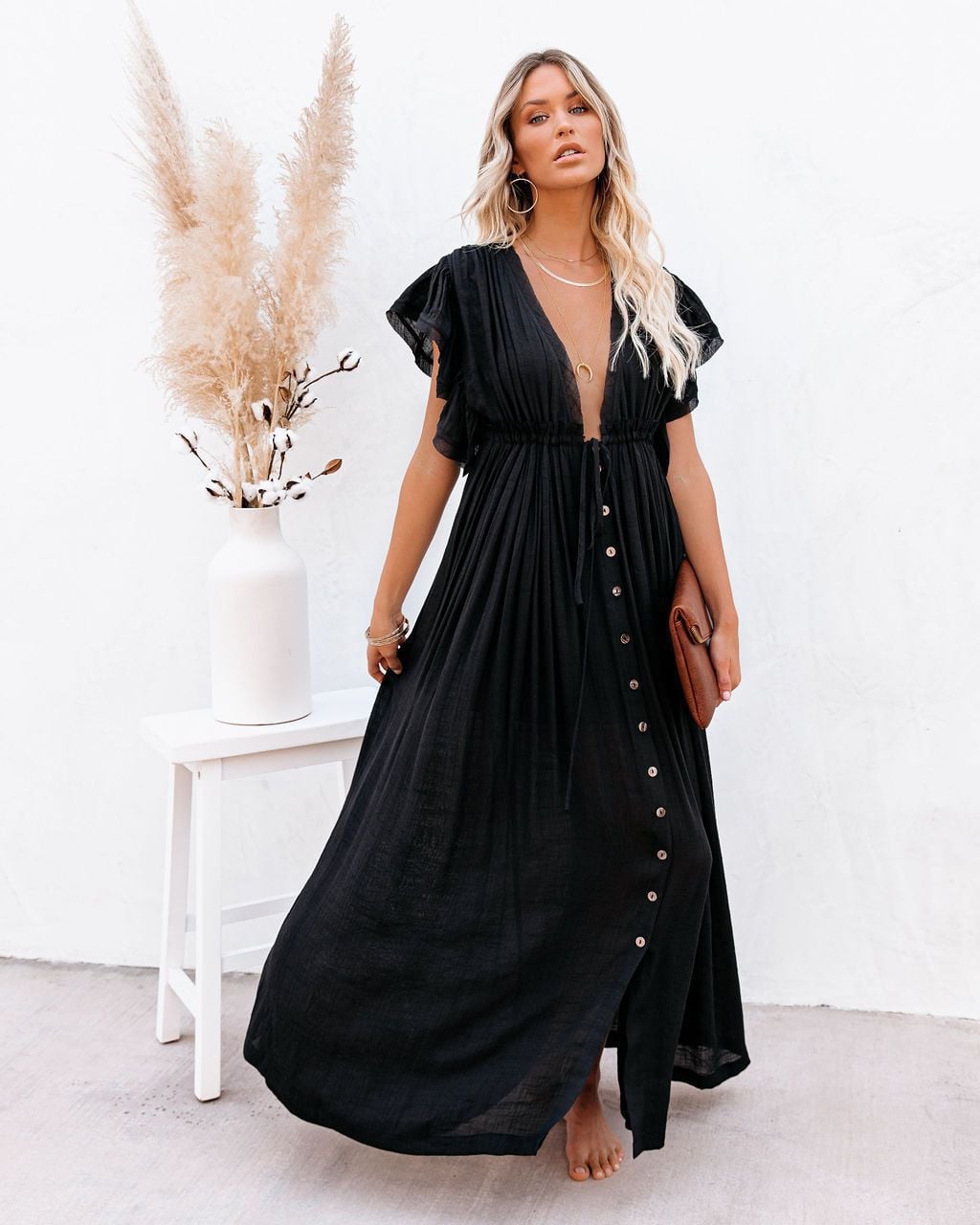 Woman wearing the Annabelle boho wrap V-neck beach cover-up in black with flowing silhouette at the beach