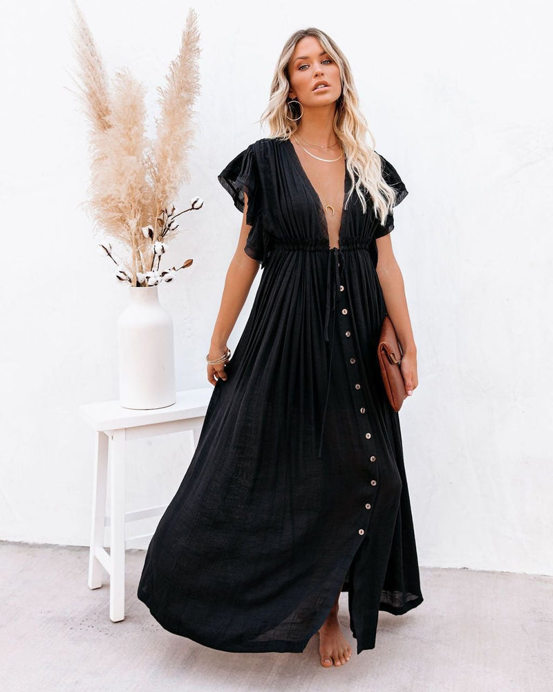 Woman wearing the Annabelle boho wrap V-neck beach cover-up in black with flowing silhouette at the beach