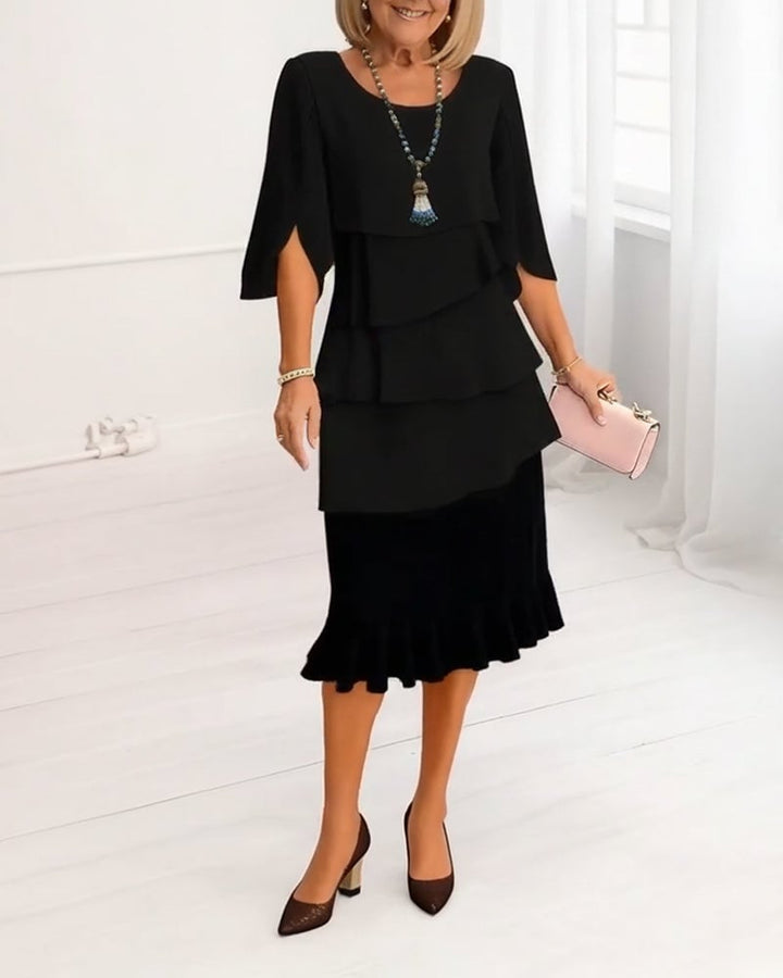 Side view of the Annabelle ruffle tiered midi dress in Black showing midi length and tiered ruffle detail