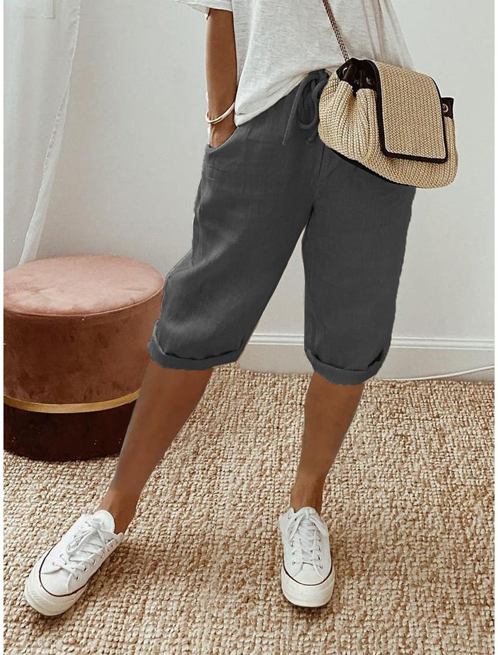 Front view of relaxed capri pants in blue showing mid-calf length and elastic drawstring waistband