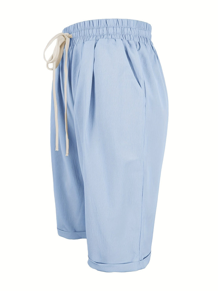 Woman in blue capri pants walking casually on a sunny day