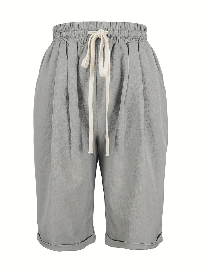 Flat lay of relaxed capri pants in gray on a light background