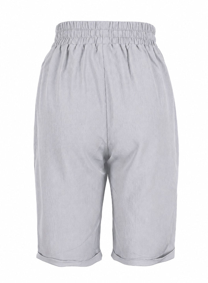 Relaxed capri pants in gray styled with strappy sandals for a summer look