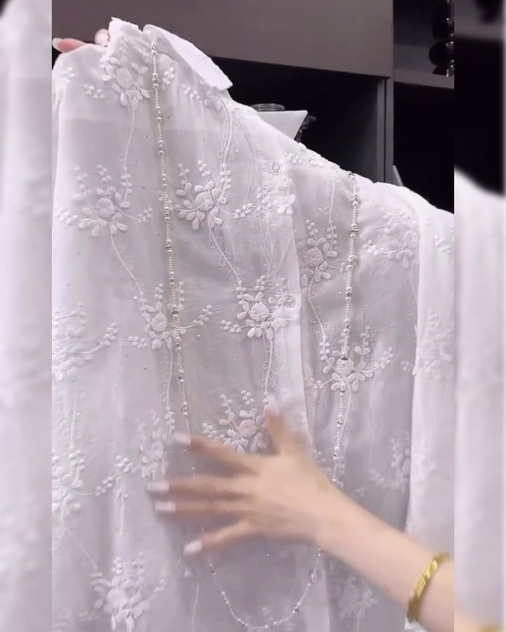 Full-length view of a white floral embroidered shirt showing length and fit
