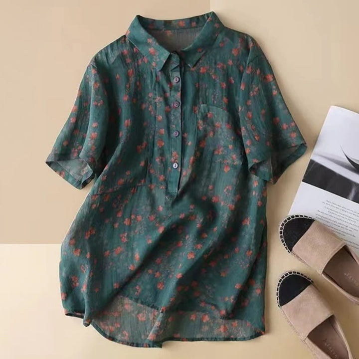 Woman wearing a green floral half-placket shirt with a relaxed fit and classic collar