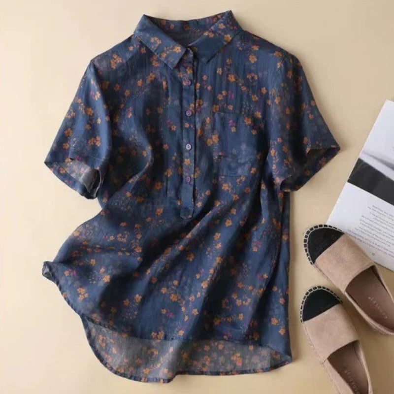 Front view of a blue floral half-placket shirt showing the half-placket neckline detail