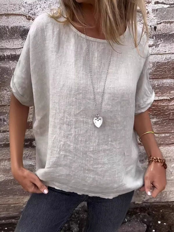 Model wearing the Annette minimalist relaxed top in a neutral tone, styled with casual bottoms for an effortless everyday look