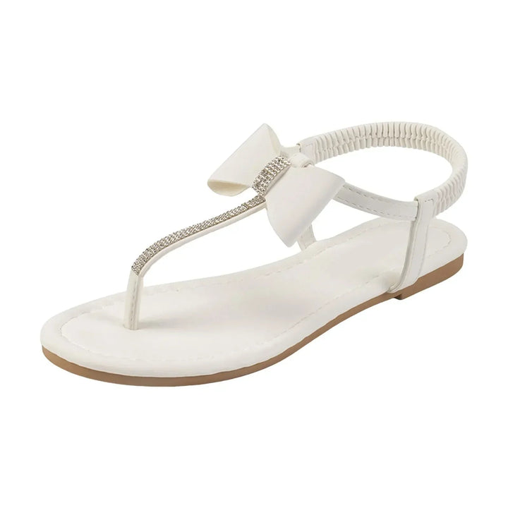 Antoinette flat sandals in white shown styled with a summer dress, detail shot