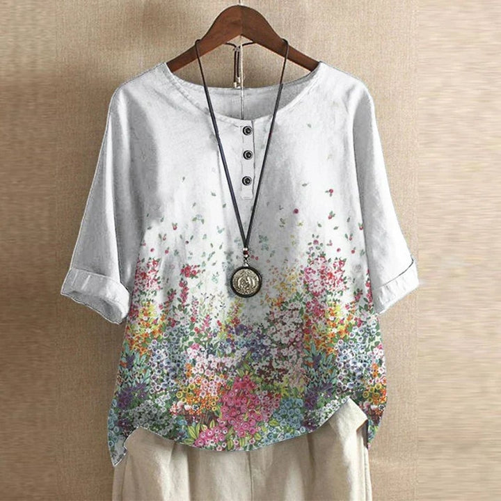 Model styling the Anya floral blouse casually with denim jeans