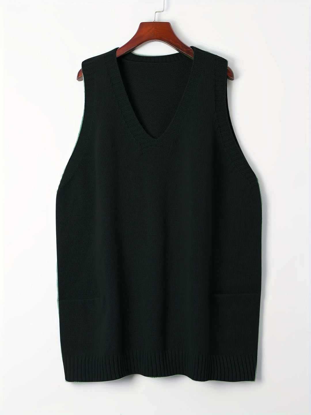 Model layering pink V-neck vest over a long-sleeve top, casual street-style look