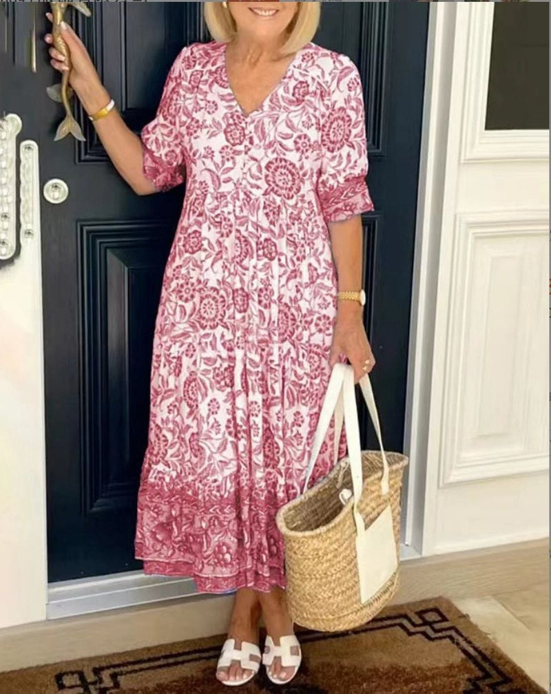 Model wearing the Aria floral dress in red, showing the relaxed fit and full-length silhouette