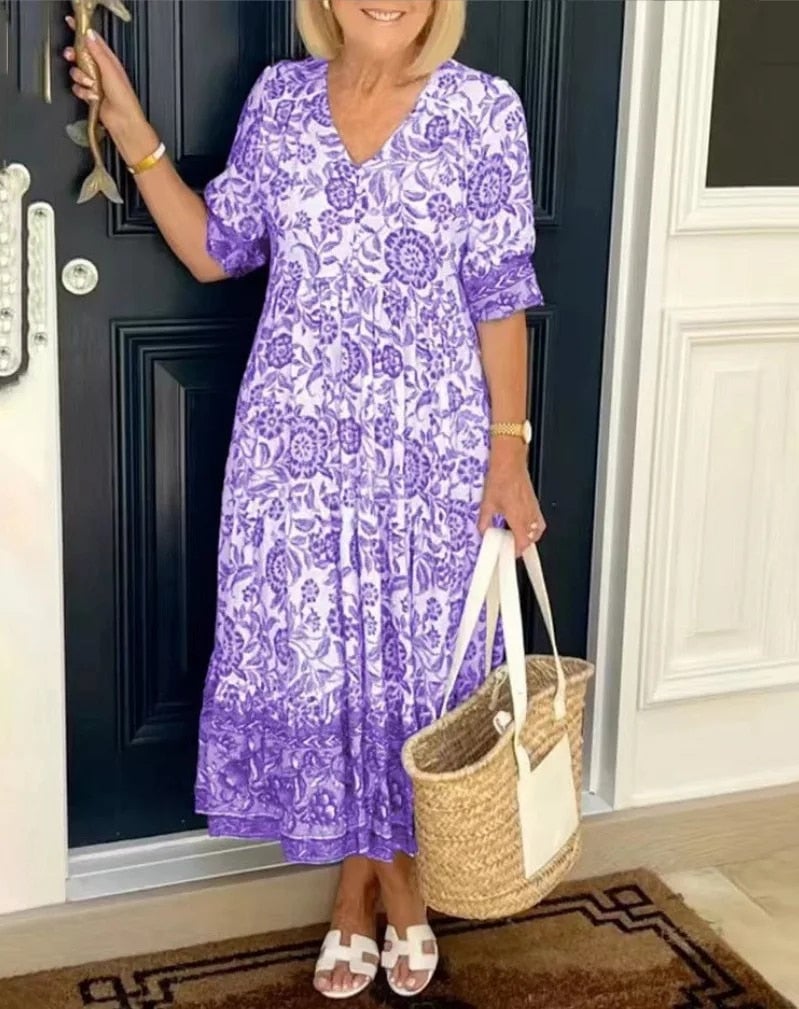 Aria floral V-neck dress in purple displayed to show the flowing fabric and feminine print