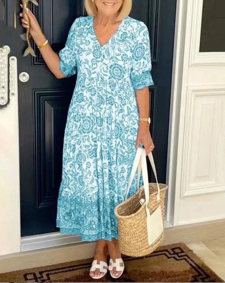 Model wearing the Aria dress in khaki, paired with casual accessories for a daytime look