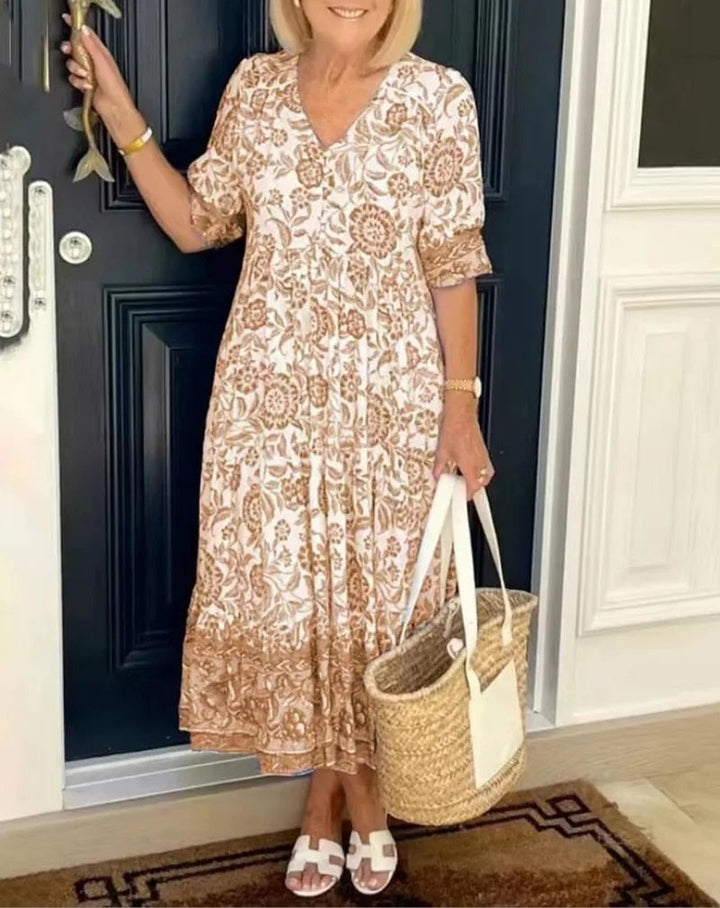 Flat lay of the Aria elegant floral V-neck dress showing print detail and overall garment shape