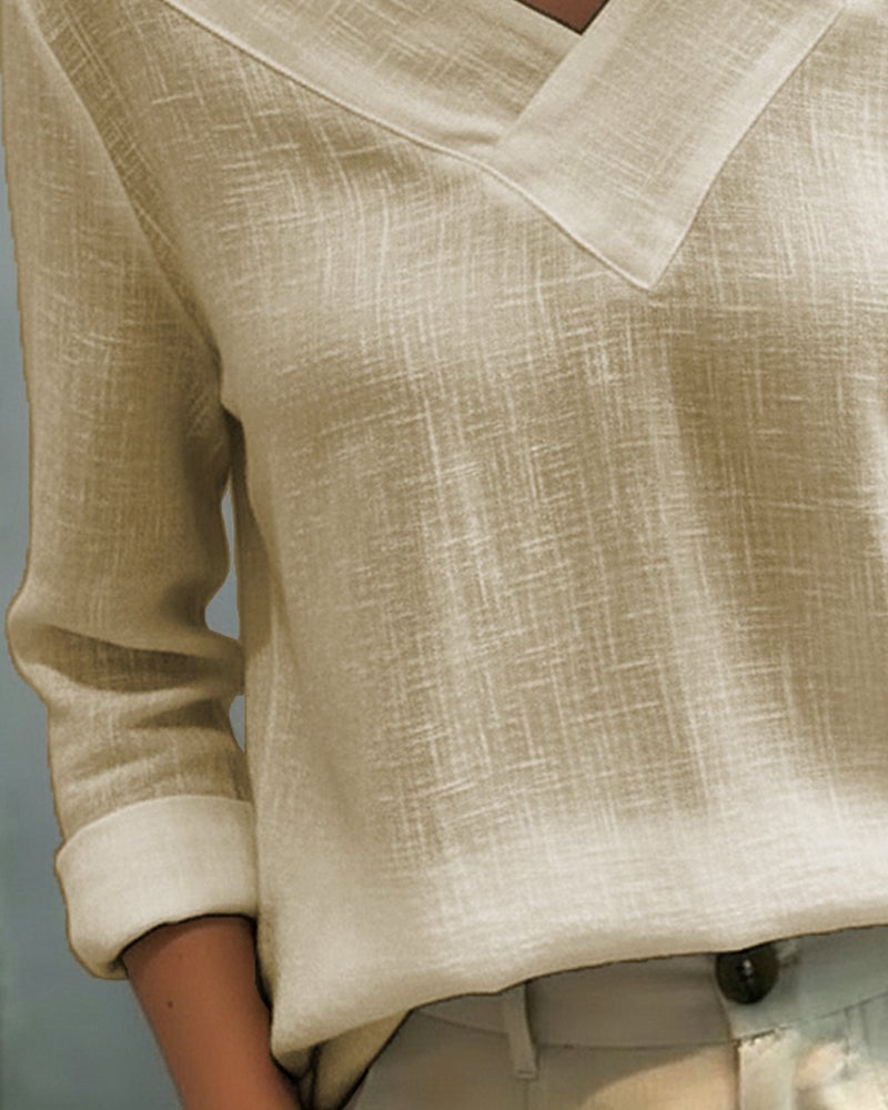 Flat lay of Aria asymmetric V-neck top showing all four color options: white, black, pink, and khaki
