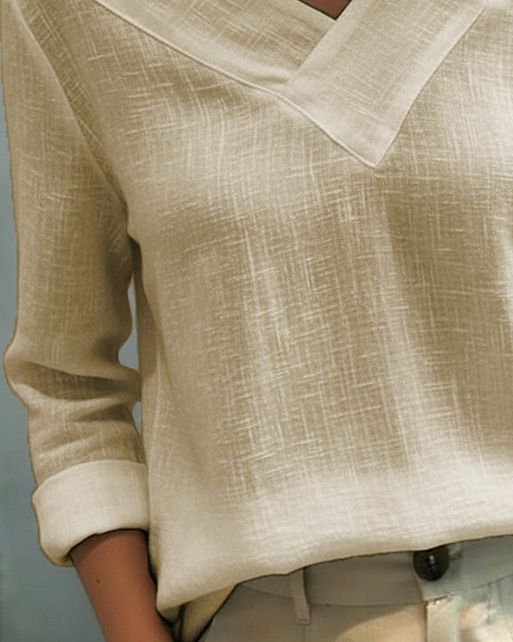 Flat lay of Aria asymmetric V-neck top showing all four color options: white, black, pink, and khaki