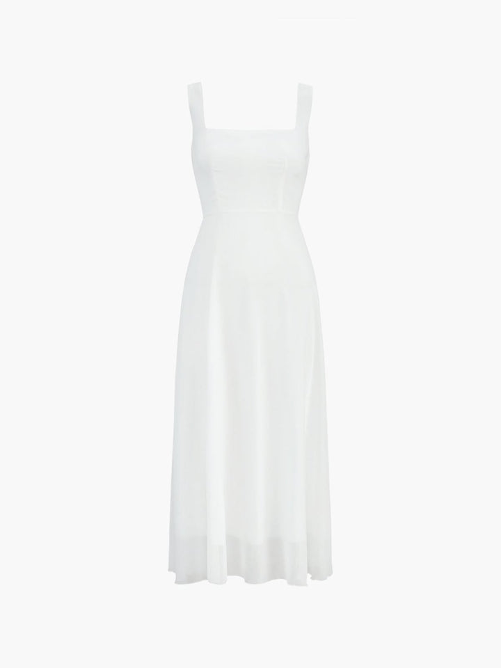 Side view of the Aria white A-line midi dress showing graceful skirt movement and below-the-knee length
