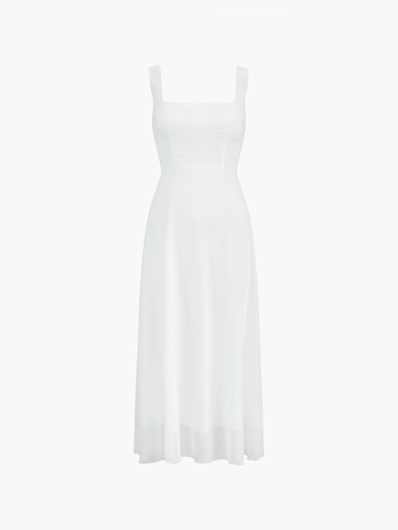 Side view of the Aria white A-line midi dress showing graceful skirt movement and below-the-knee length