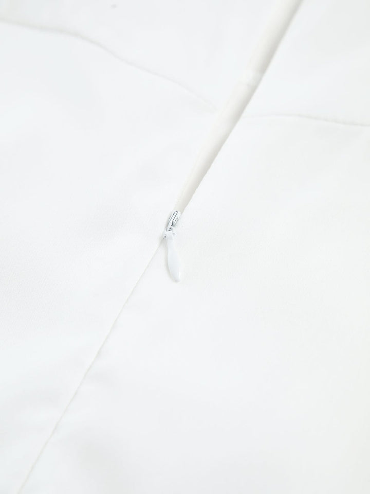 Close-up of the Aria black midi dress fitted bodice and flowing A-line skirt detail